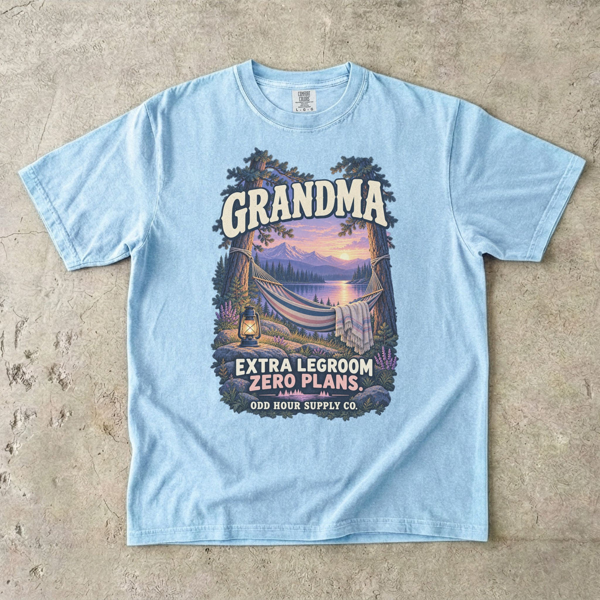 Chambray Comfort Colors 1717 T-shirt with a hammock between trees, a lake, mountains, a lantern, and Grandma Extra Legroom Zero Plans lettering.
