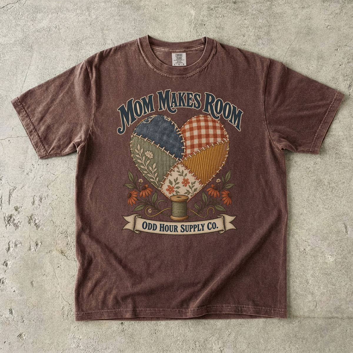 Espresso Comfort Colors 1717 T-shirt with a heart made of patterned fabric patches, flowers, a spool of thread, and Mom Makes Room lettering.