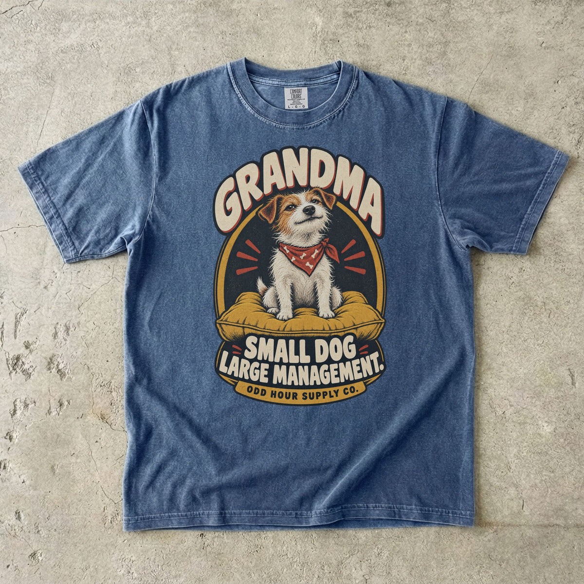 Denim Comfort Colors 1717 T-shirt with a terrier on a mustard cushion, a red bandana, and Grandma Small Dog Large Management lettering.