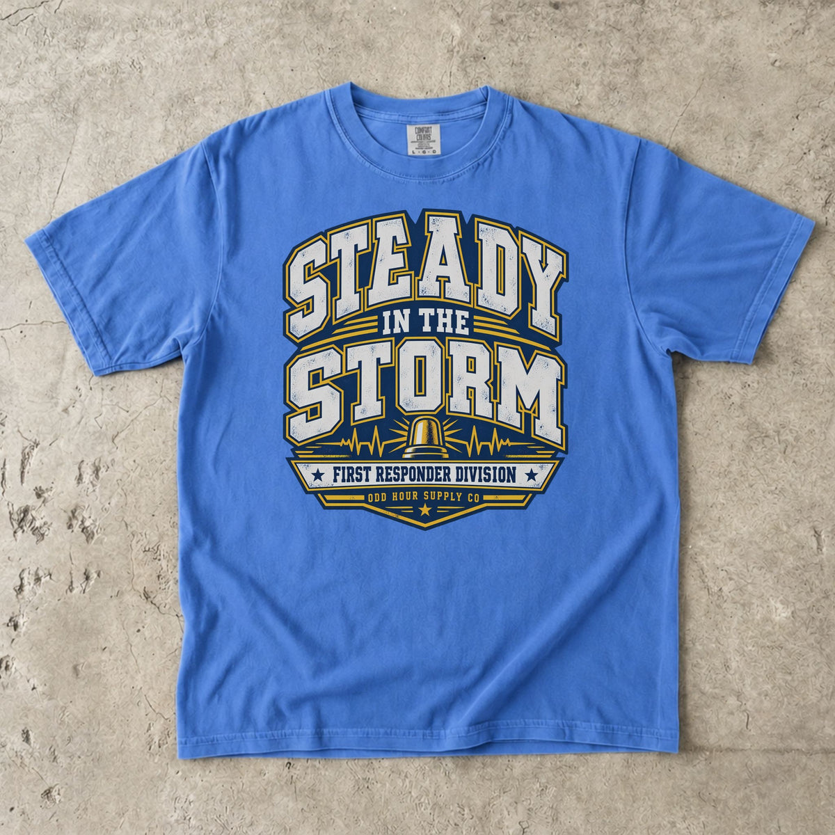Flo Blue Comfort Colors 1717 T-shirt with Steady in the Storm college graphic, yellow beacon, pulse lines and First Responder Division text.