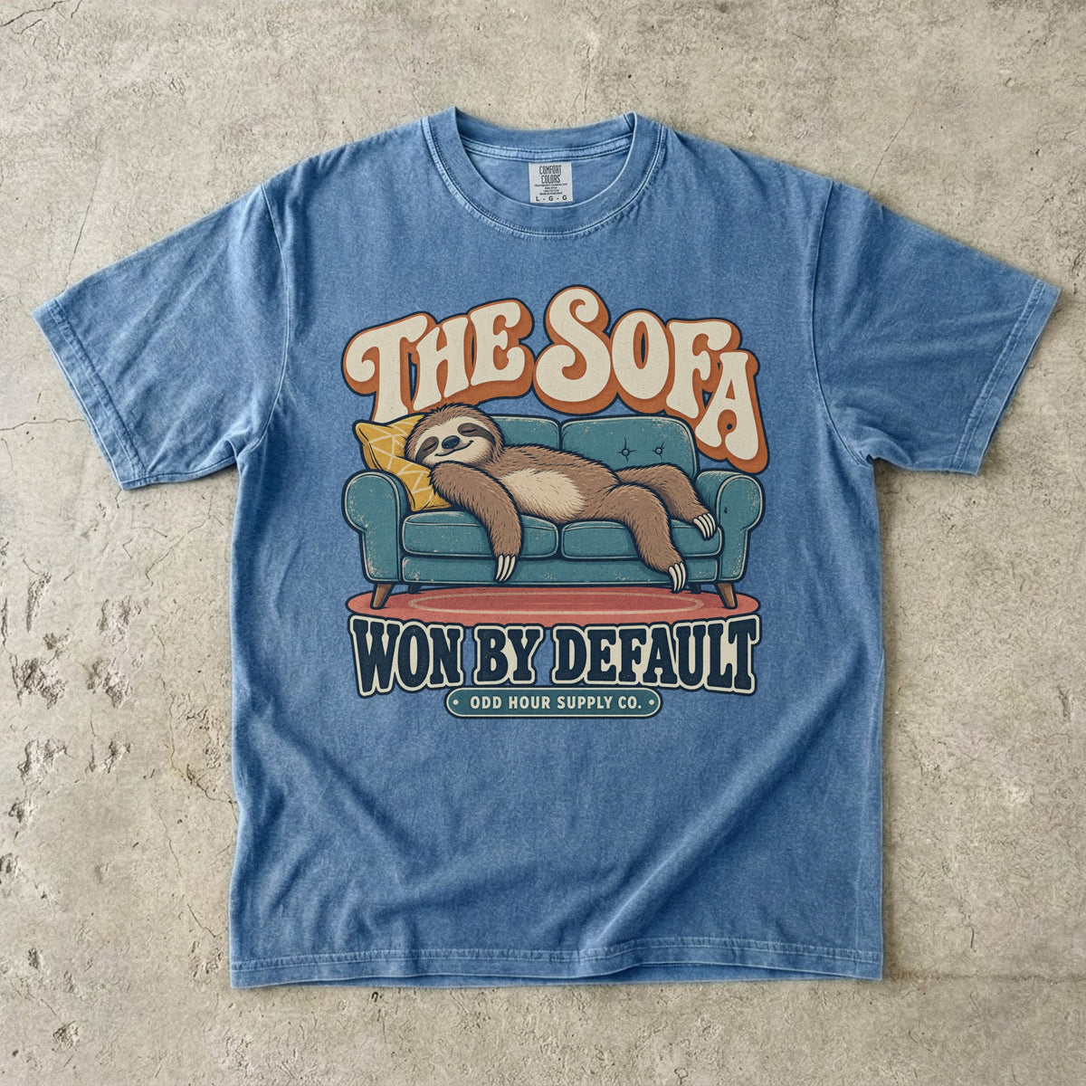 Blue Jean T-shirt with a lounging sloth on a sofa and THE SOFA WON BY DEFAULT by Odd Hour Supply Co.