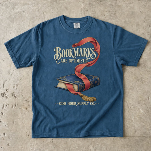 Midnight T-shirt featuring a blue book, red bookmark and BOOKMARKS ARE OPTIMISTIC by Odd Hour Supply Co.