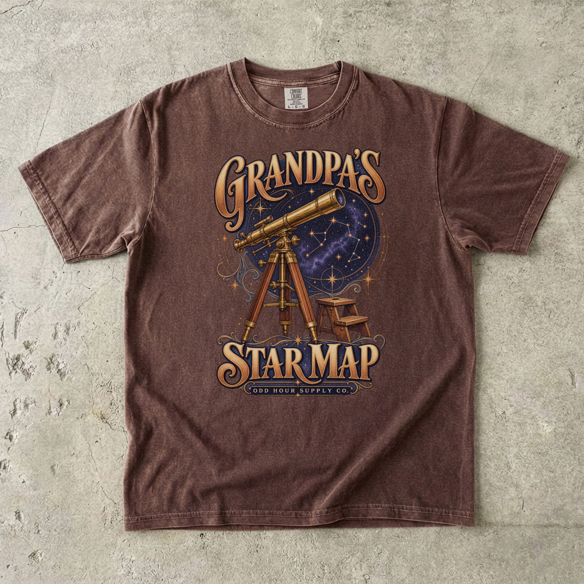 Espresso T-shirt with GRANDPA’S STAR MAP, a brass telescope, a starry sky and a small stool by Odd Hour Supply Co.