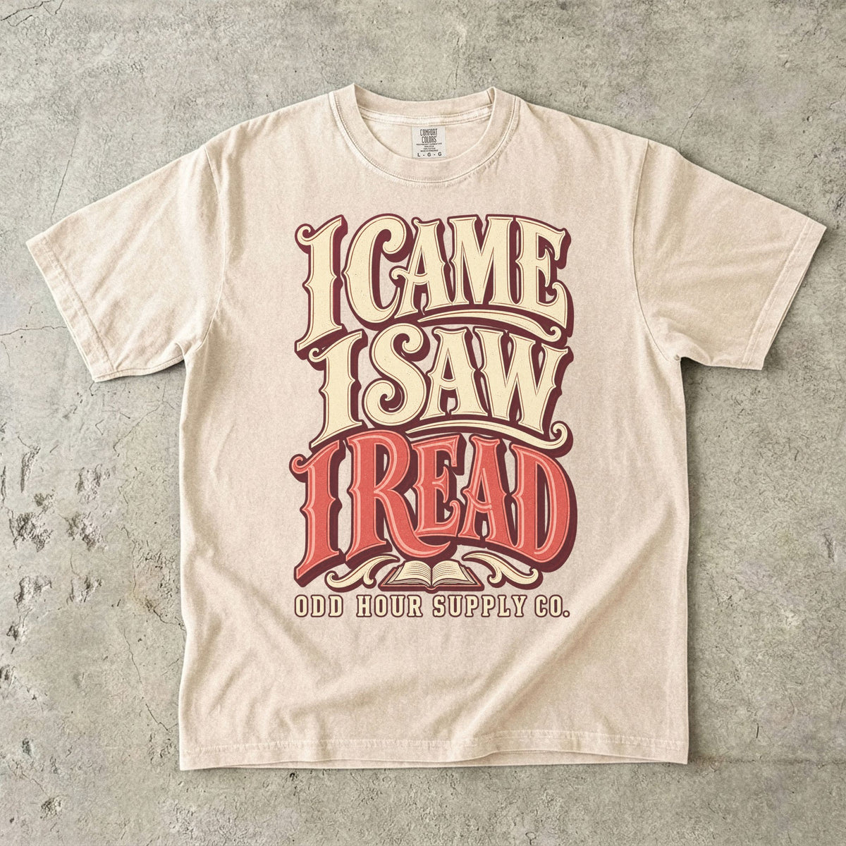 Ivory T-shirt with bold retro I CAME I SAW I READ lettering and Odd Hour Supply Co. branding.