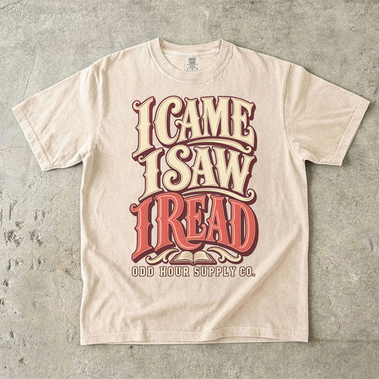Ivory T-shirt with bold retro I CAME I SAW I READ lettering and Odd Hour Supply Co. branding.