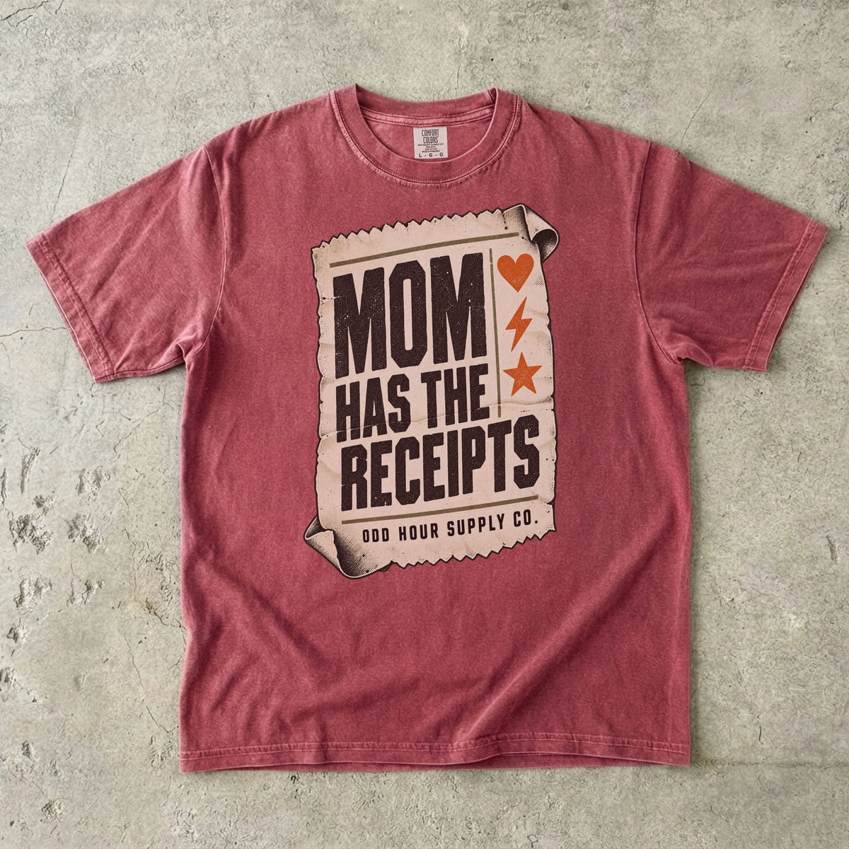 Brick Comfort Colors 1717 T-shirt with a cream receipt, black Mom Has the Receipts lettering, and orange heart, lightning bolt, and star symbols.