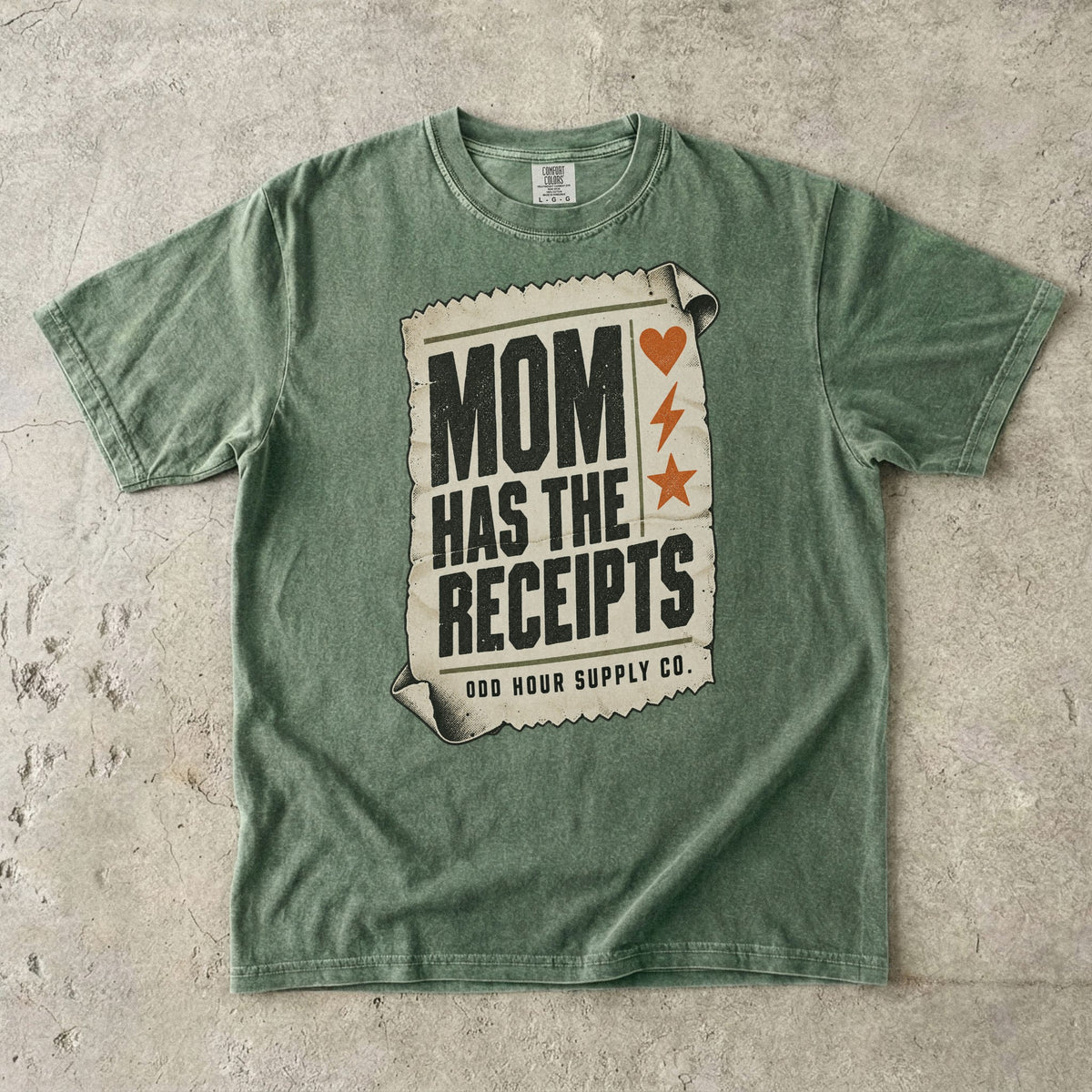 Moss Comfort Colors 1717 T-shirt with a cream receipt, black Mom Has the Receipts lettering, and orange heart, lightning bolt, and star symbols.