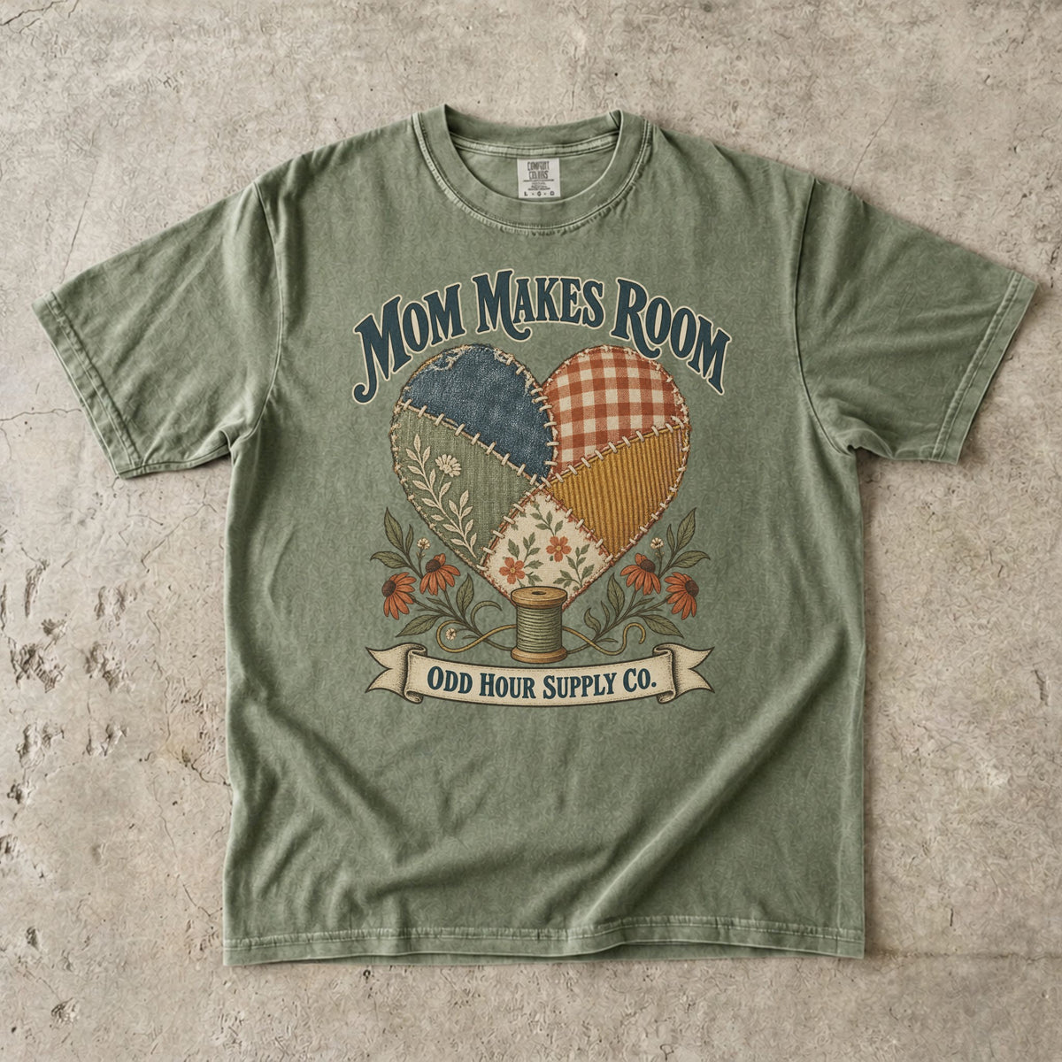 Hemp Comfort Colors 1717 T-shirt with a heart made of patterned fabric patches, flowers, a spool of thread, and Mom Makes Room lettering.