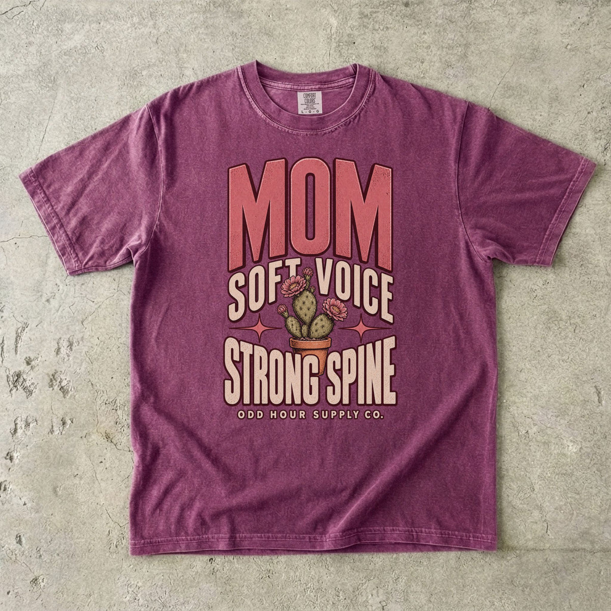 Berry Comfort Colors 1717 T-shirt with pink Mom lettering, Soft Voice Strong Spine text, and a flowering cactus in a terracotta pot.