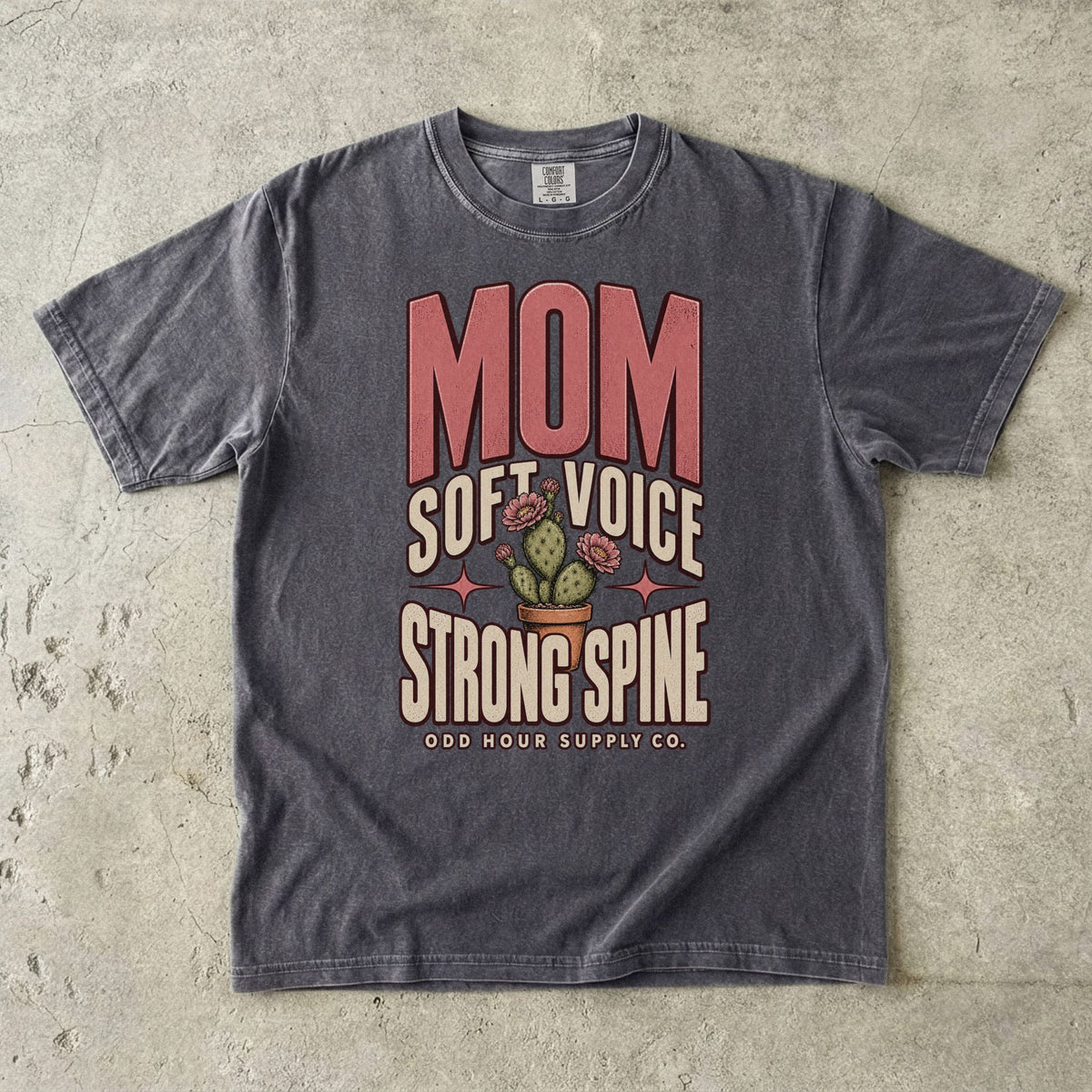Pepper Comfort Colors 1717 T-shirt with pink Mom lettering, Soft Voice Strong Spine text, and a flowering cactus in a terracotta pot.