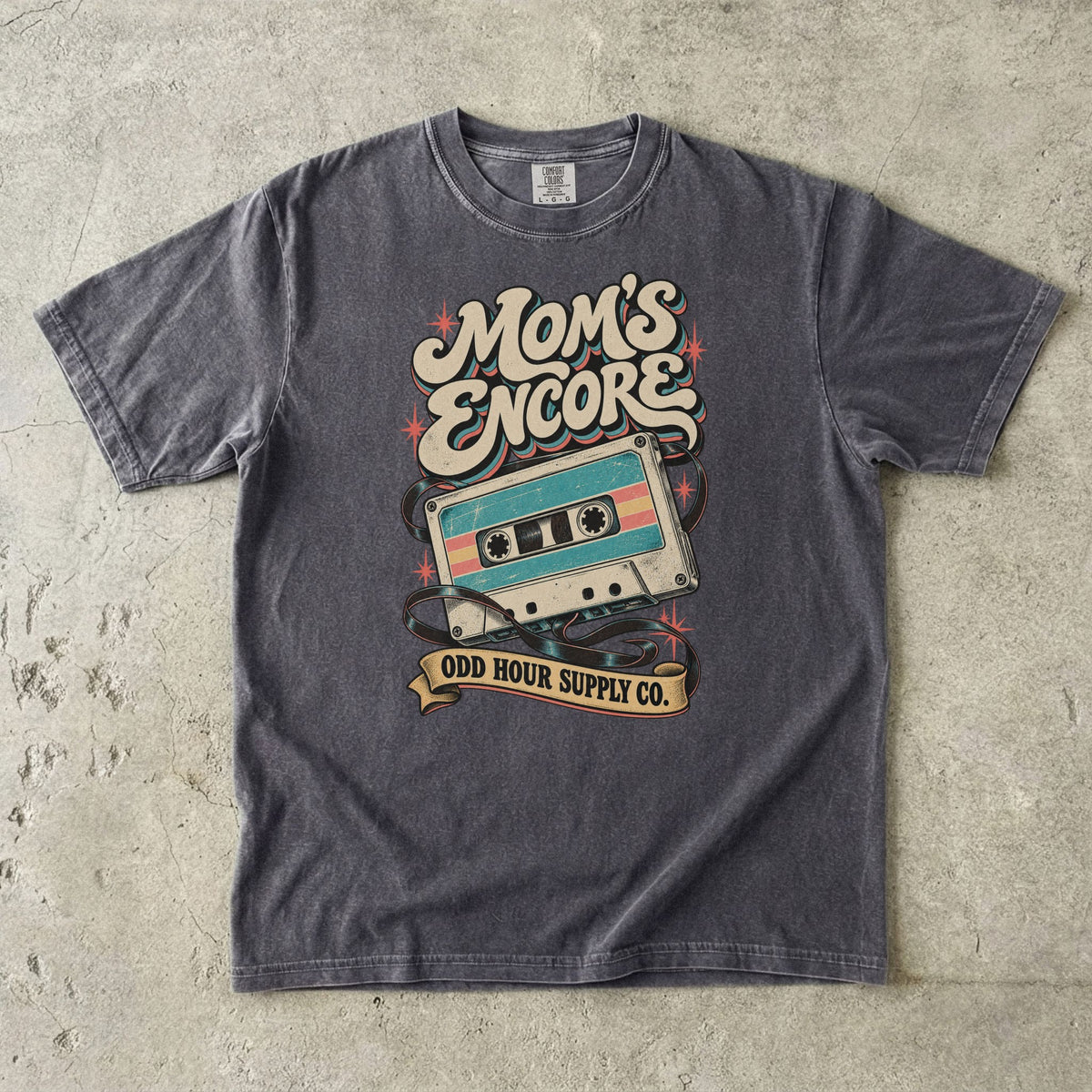 Pepper Comfort Colors 1717 T-shirt with a turquoise and cream cassette, loose tape, coral stars, and Mom’s Encore lettering.