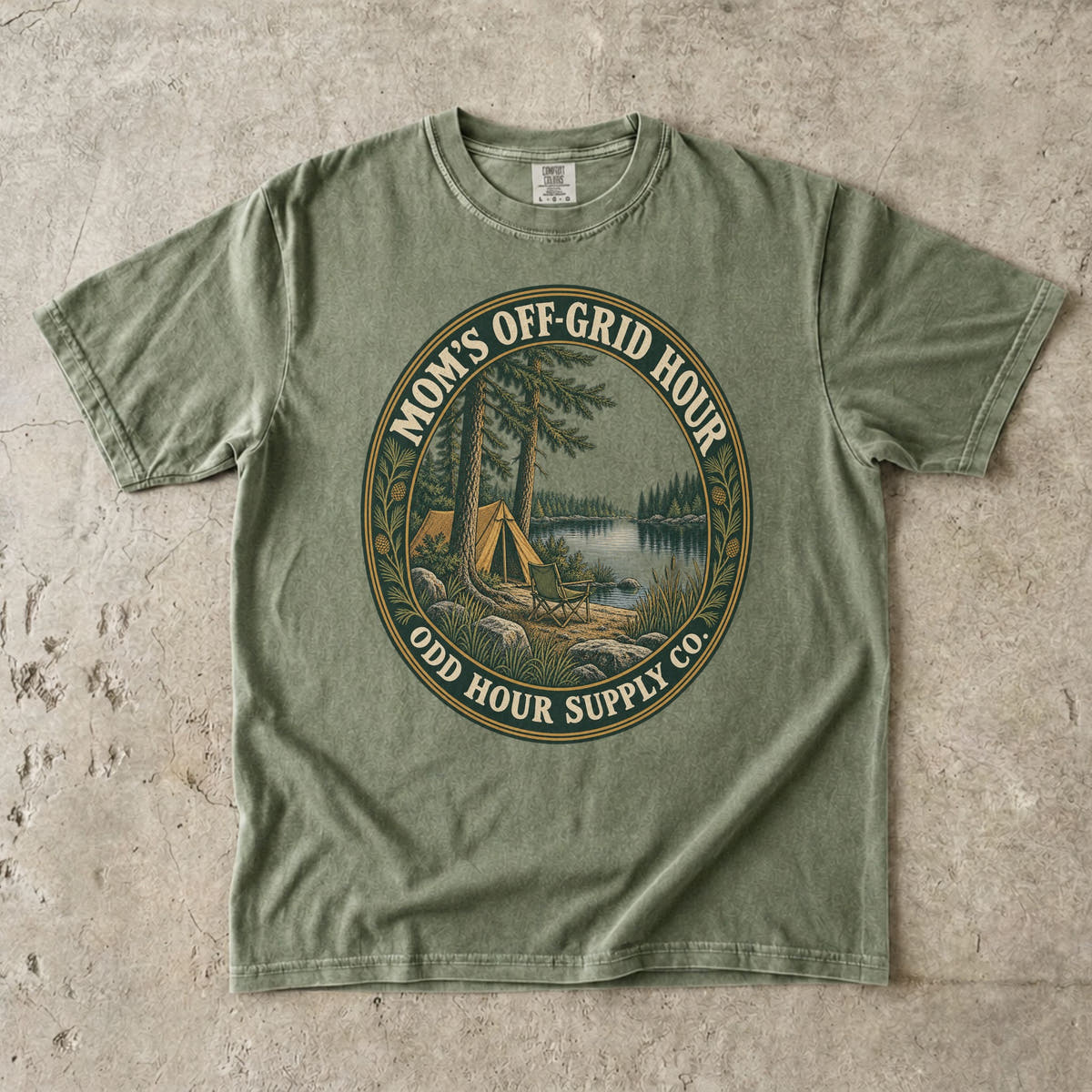 Hemp Comfort Colors 1717 T-shirt with an oval Mom’s Off-Grid Hour badge showing a tent, a camp chair, pine trees, and a lake.