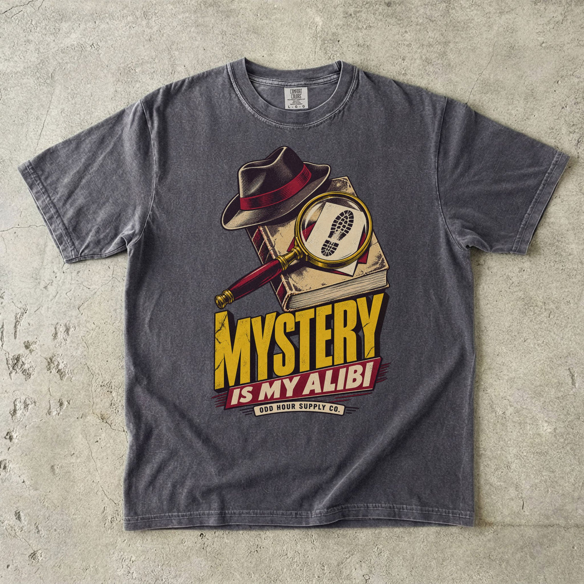 Pepper T-shirt with a detective hat, magnifying glass and yellow-red MYSTERY IS MY ALIBI by Odd Hour Supply Co.
