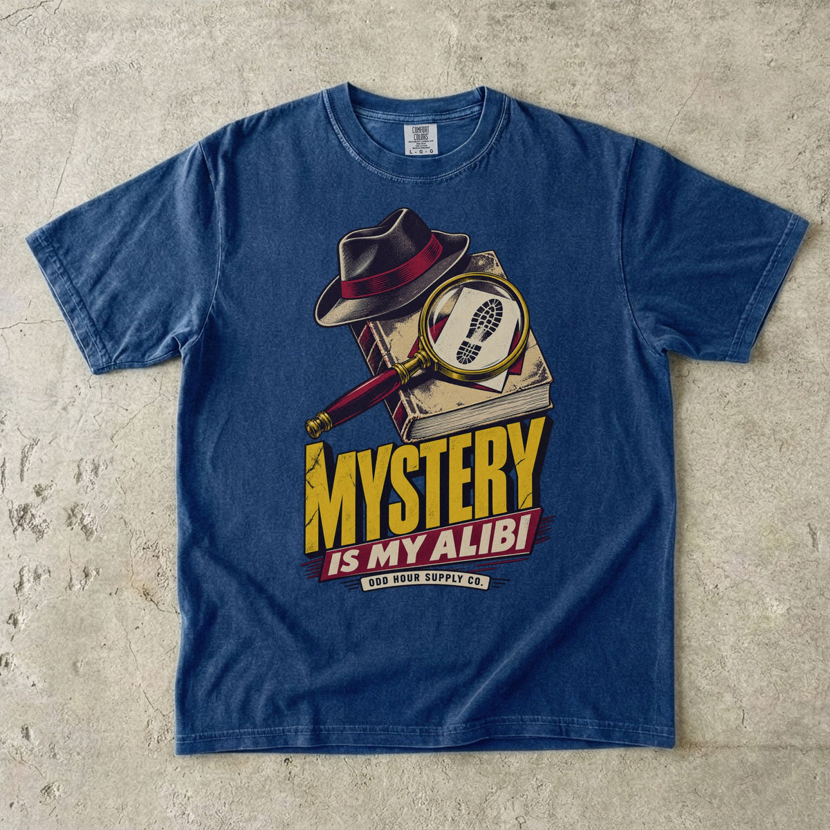 True Navy T-shirt with a detective hat, magnifying glass and yellow-red MYSTERY IS MY ALIBI by Odd Hour Supply Co.