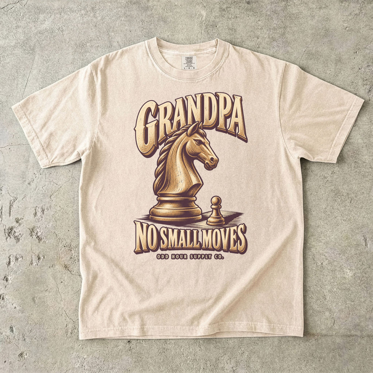 Ivory T-shirt with GRANDPA NO SMALL MOVES, a golden chess knight and pawn by Odd Hour Supply Co.