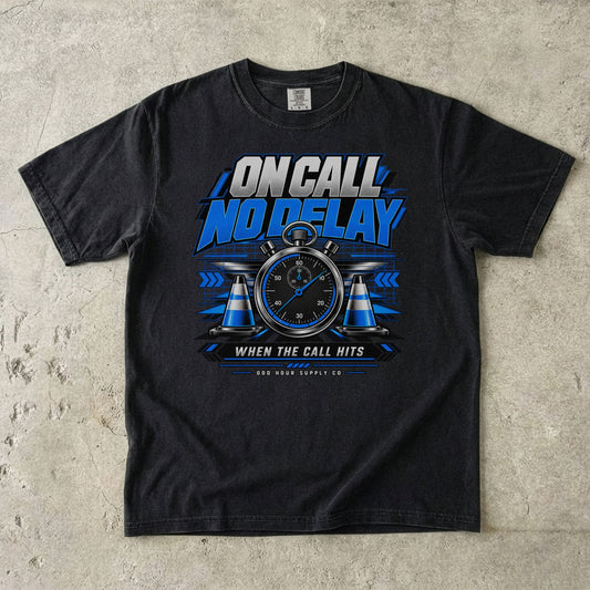 Black Comfort Colors 1717 T-shirt with On Call No Delay front graphic, blue stopwatch, cones and silver lettering.