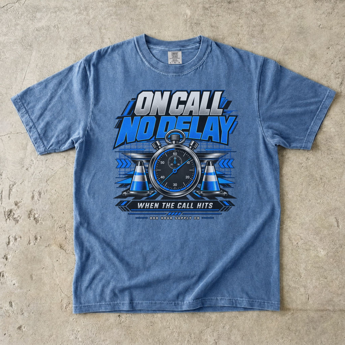 Washed Denim Comfort Colors 1717 T-shirt with On Call No Delay front graphic, blue stopwatch, cones and silver lettering.