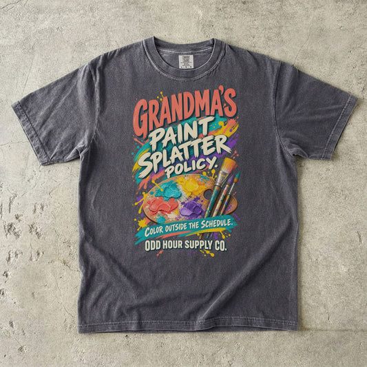 Pepper Comfort Colors 1717 T-shirt with an artist’s palette, paintbrushes, paint splashes, and Grandma’s Paint Splatter Policy and Color Outside the Schedule lettering.