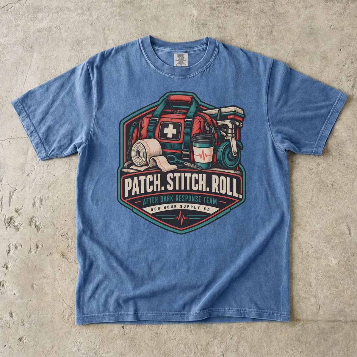 Washed Denim Comfort Colors 1717 T-shirt with Patch Stitch Roll badge, coral medical bag, bandages, coffee cup and teal details.
