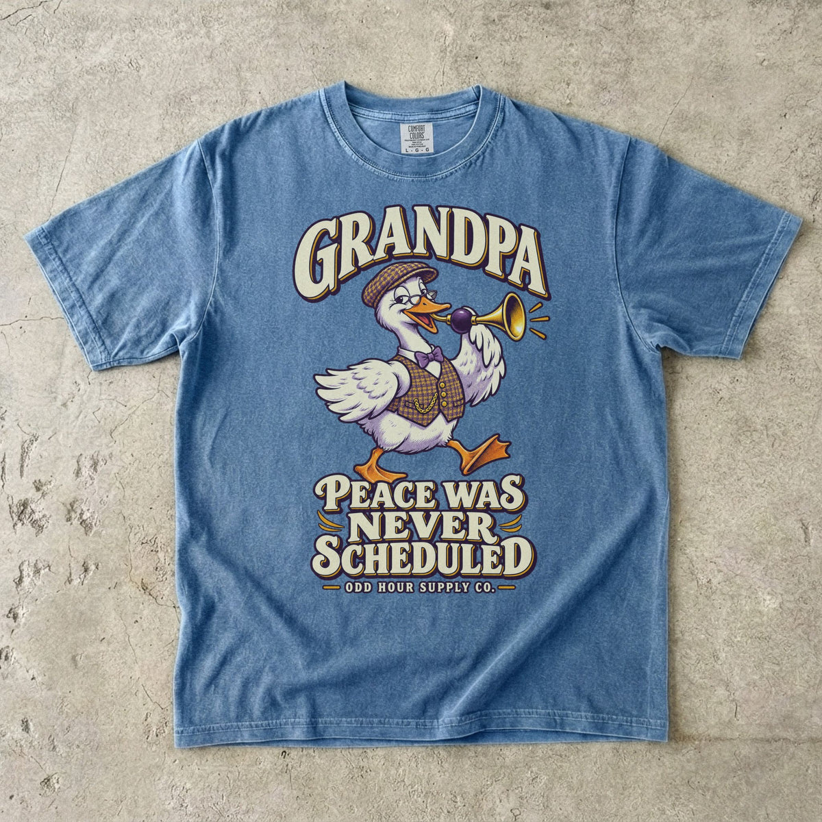 Blue Jean T-shirt with GRANDPA PEACE WAS NEVER SCHEDULED and a goose wearing glasses and a flat cap, holding a horn, by Odd Hour Supply Co.