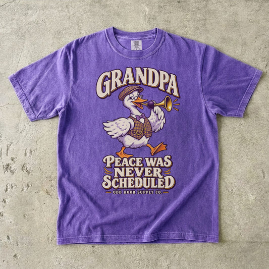 Violet T-shirt with GRANDPA PEACE WAS NEVER SCHEDULED and a goose wearing glasses and a flat cap, holding a horn, by Odd Hour Supply Co.