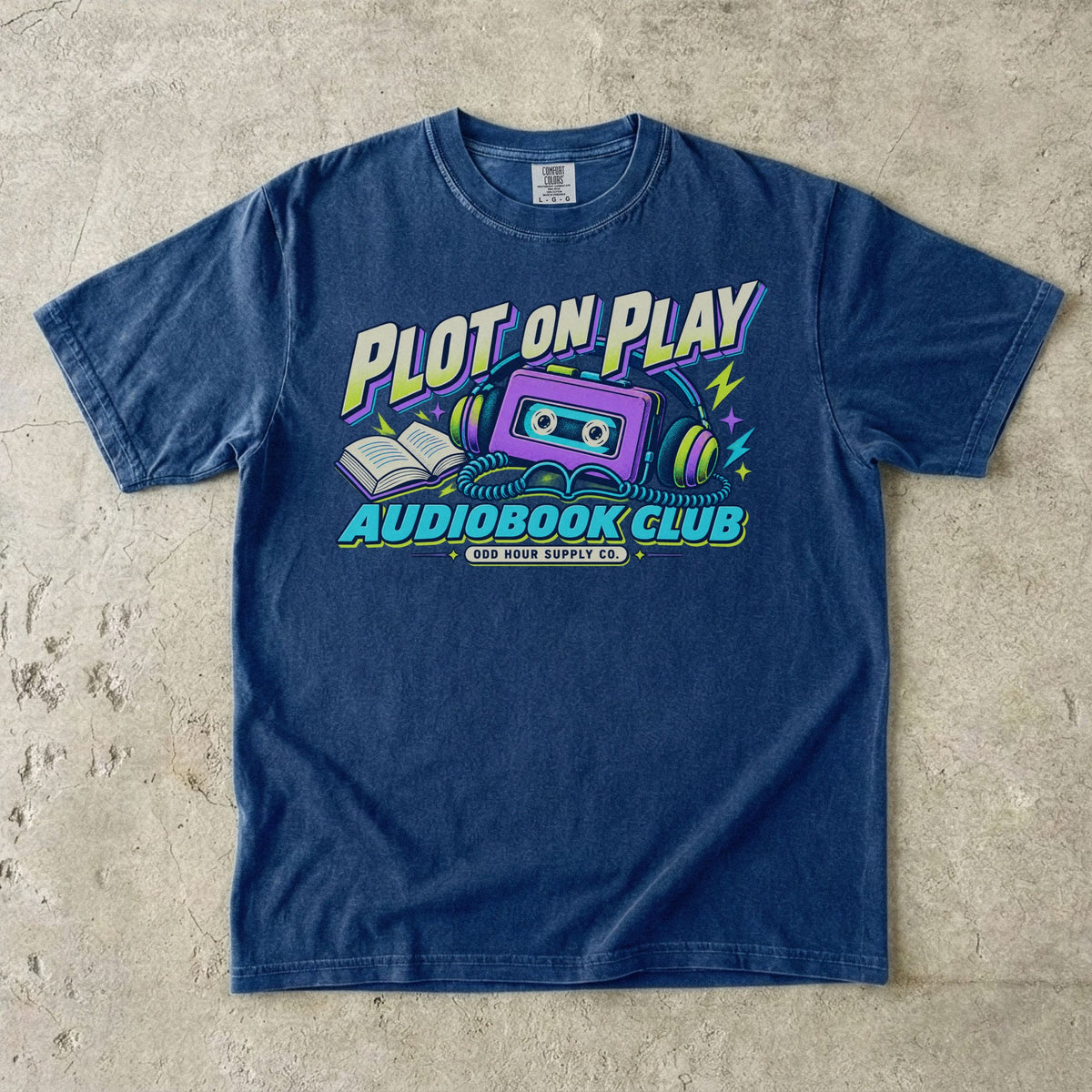 True Navy T-shirt featuring a purple cassette, headphones and PLOT ON PLAY AUDIOBOOK CLUB by Odd Hour Supply Co.