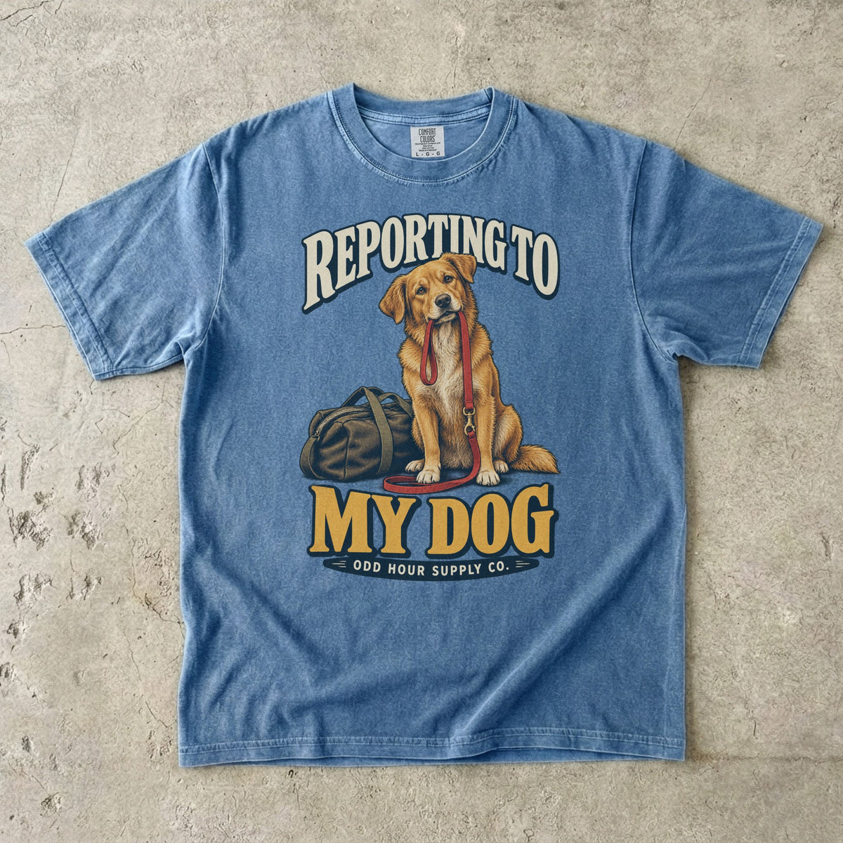 Blue Jean T-shirt with a golden-brown dog, red leash and REPORTING TO MY DOG lettering by Odd Hour Supply Co.