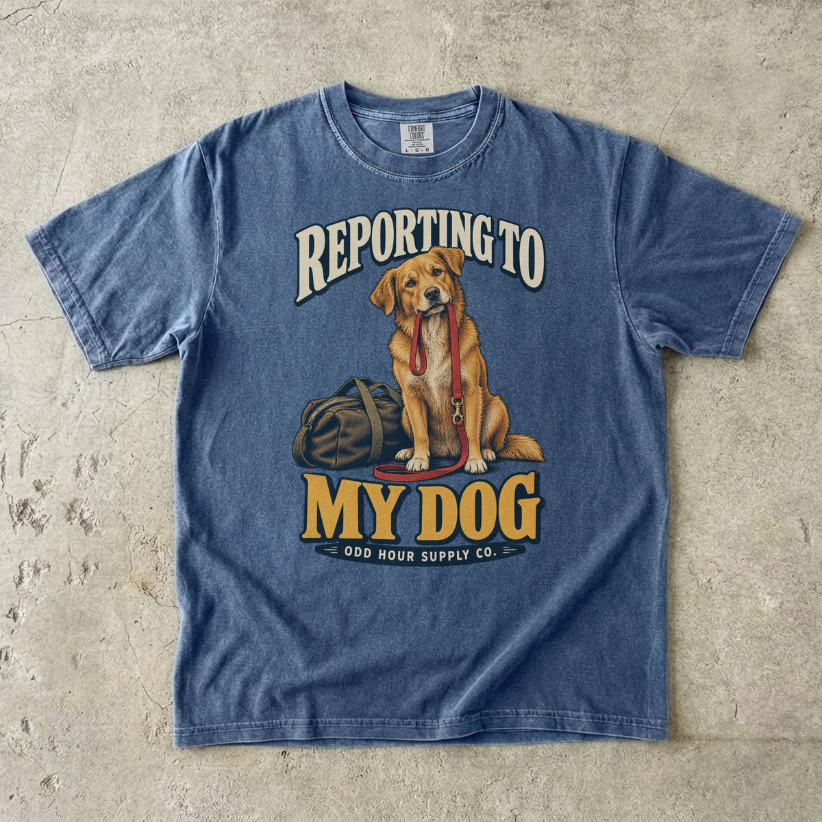 Denim T-shirt with a golden-brown dog, red leash and REPORTING TO MY DOG lettering by Odd Hour Supply Co.