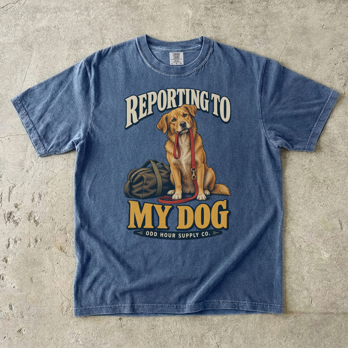 Denim T-shirt with a golden-brown dog, red leash and REPORTING TO MY DOG lettering by Odd Hour Supply Co.