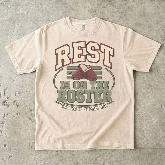 Ivory T-shirt with collegiate REST IS ON THE ROSTER lettering, red slippers and Odd Hour Supply Co. branding.