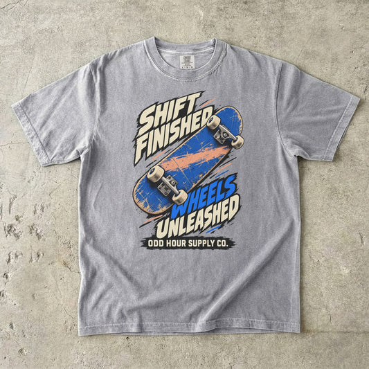 Grey T-shirt with a blue skateboard and SHIFT FINISHED WHEELS UNLEASHED lettering by Odd Hour Supply Co.