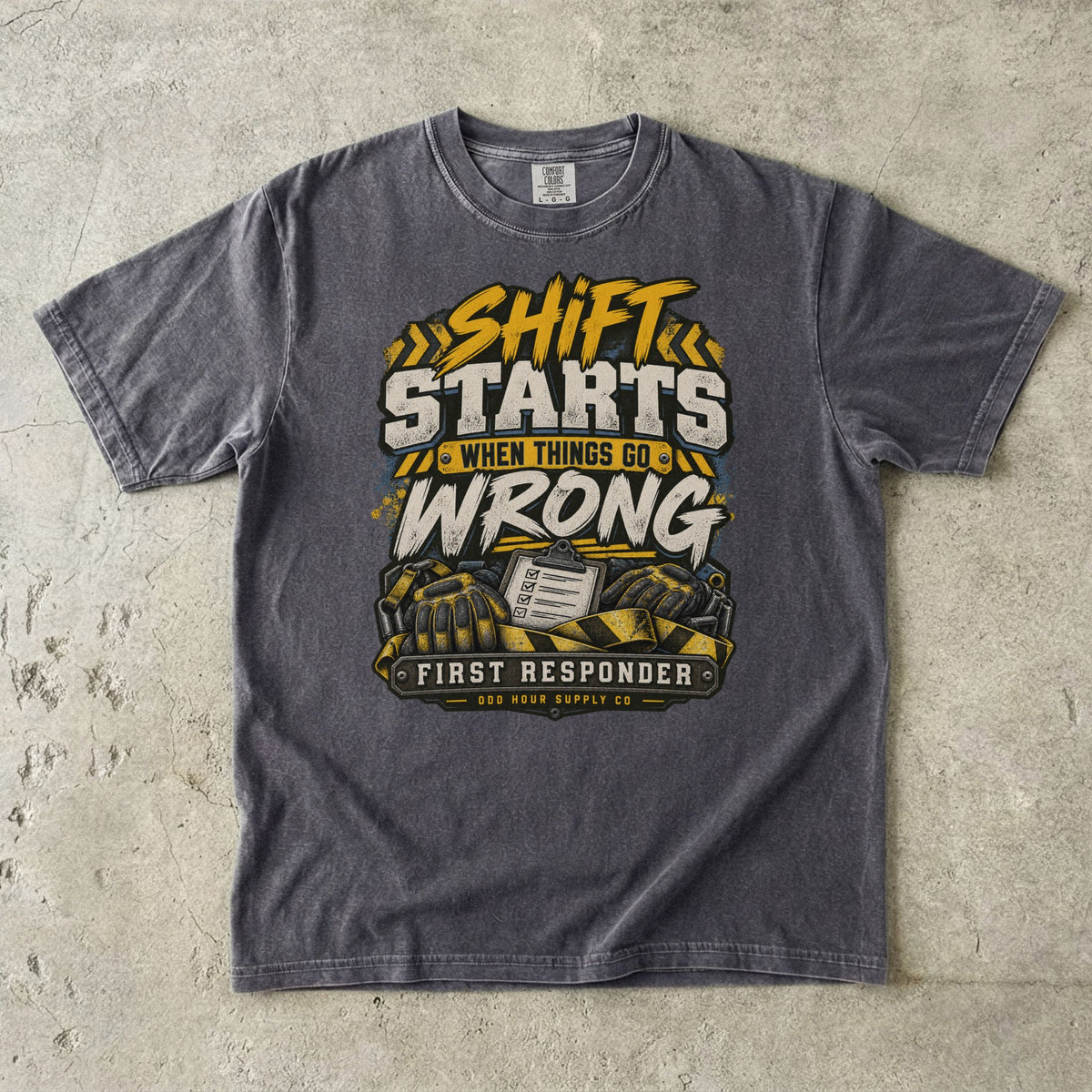 Pepper Comfort Colors 1717 T-shirt with Shift Starts When Things Go Wrong graphic, yellow hazard stripes, gloves and clipboard.