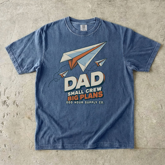 Denim Comfort Colors 1717 T-shirt with three paper planes, dotted flight paths, and Dad Small Crew Big Plans lettering.