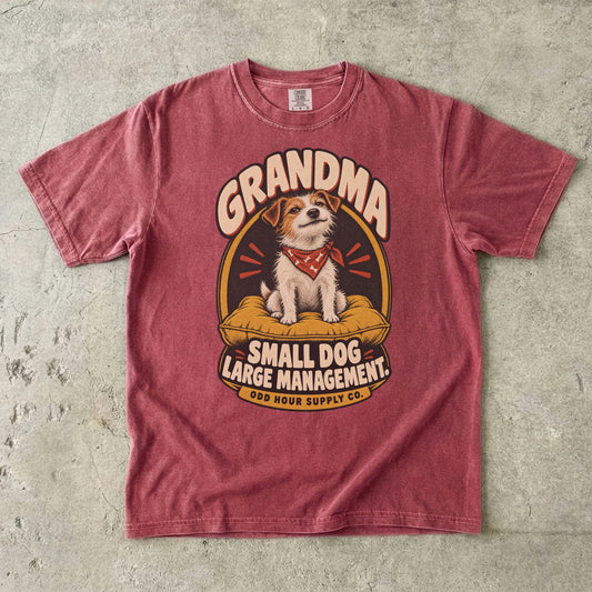 Brick Comfort Colors 1717 T-shirt with a terrier on a mustard cushion, a red bandana, and Grandma Small Dog Large Management lettering.