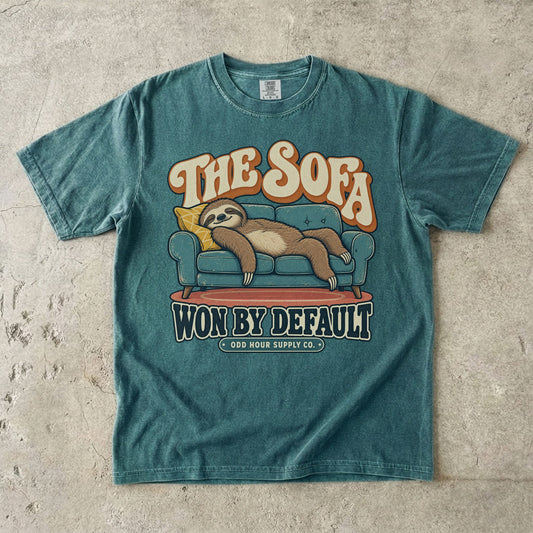 Blue Spruce T-shirt with a lounging sloth on a sofa and THE SOFA WON BY DEFAULT by Odd Hour Supply Co.