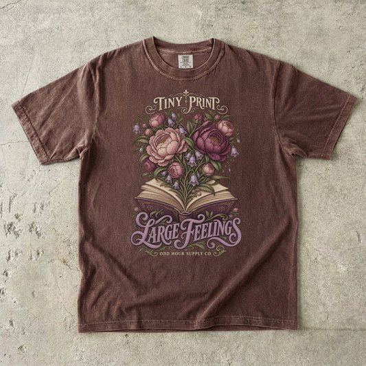 Espresso T-shirt featuring flowers rising from an open book and TINY PRINT LARGE FEELINGS by Odd Hour Supply Co.