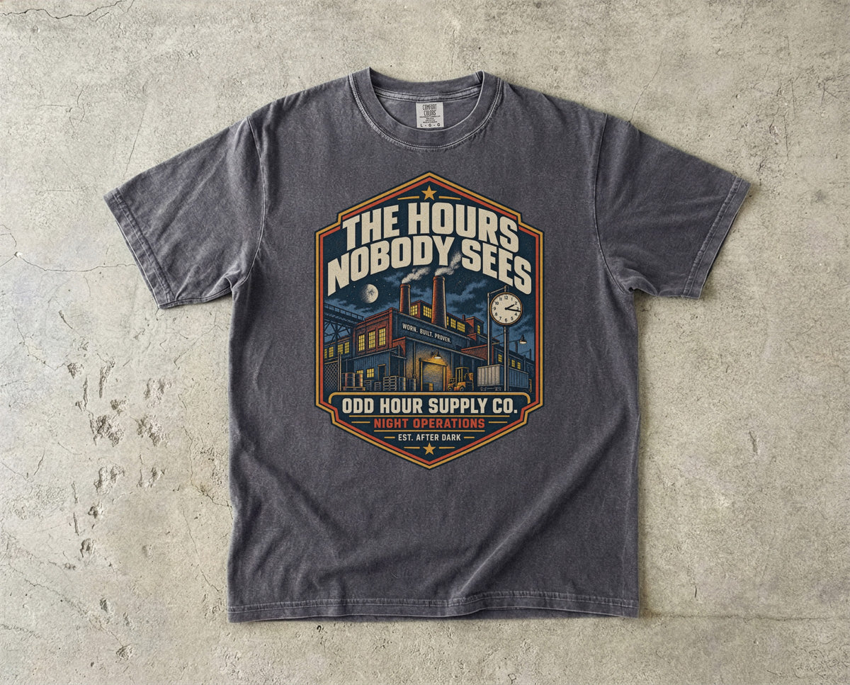 The Hours Nobody Sees vintage badge T-shirt in Pepper, Comfort Colors 1717 front view