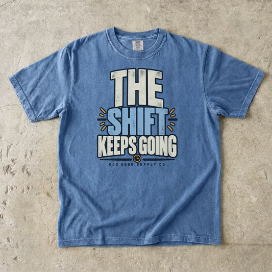 The Shift Keeps Going typography on a Washed Denim Comfort Colors T-shirt